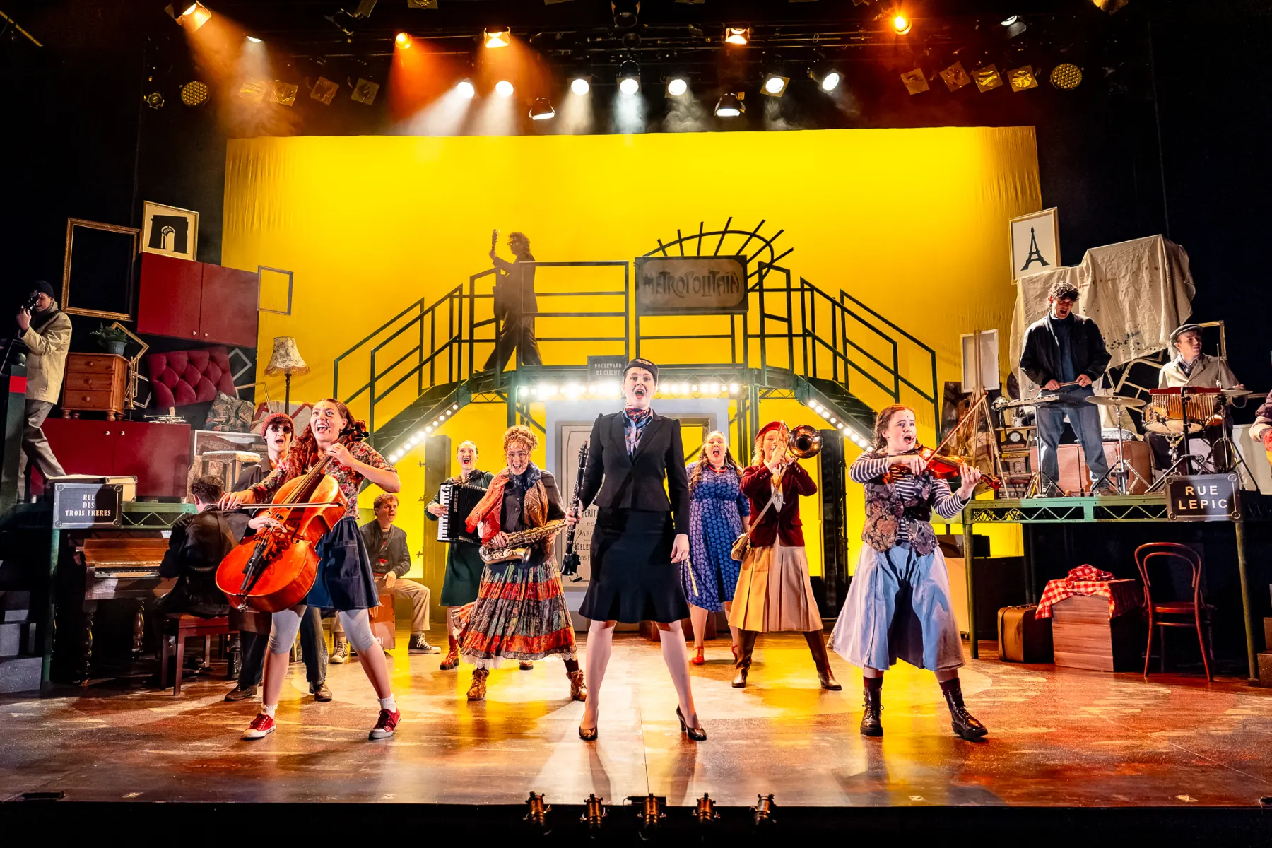 The Amélie company in performance, every performer playing an instrument on stage